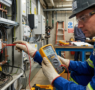 Engineer performing an insulation resistance test using a megohmmeter